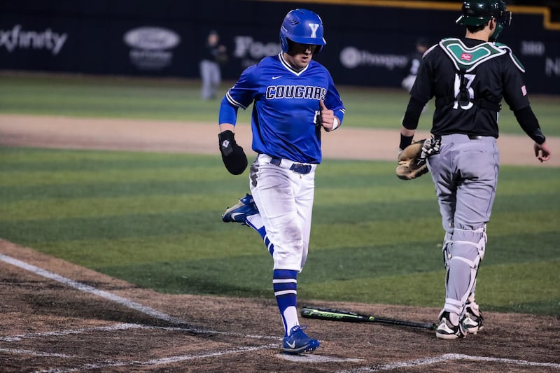 BYU's Jackson Cluff scores on a single by Keaton Kringlen during a game against UVU at Miller Park in Provo on Tuesday, March 5, 2019.