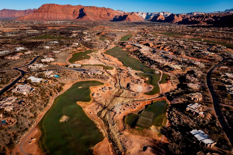 The Entrada at Snow Canyon golf course in St. George is pictured against a backdrop of red rock cliffs on Saturday, Feb. 19, 2022.