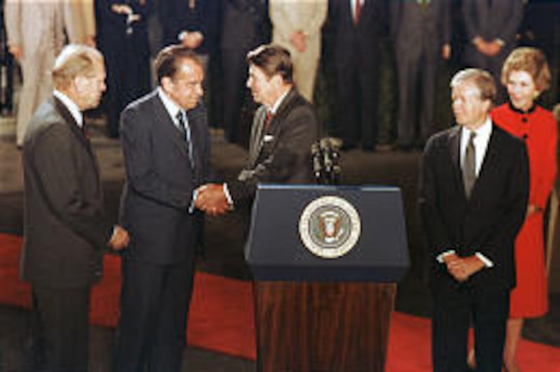 President Ronald Reagan, behind podium, shakes hands with former President Richard Nixon as ex-presidents Gerald Ford, left, and Jimmy Carter look on at the White House in October 1981. Nixon said in tape Reagan wasn't pleasant to be around.