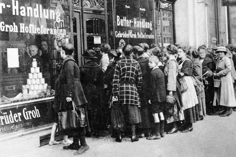 Lines formed for groceries in Berlin in 1923 as the value of the German Reichsmark became worthless because of hyperinflation.