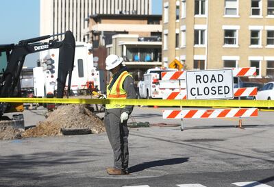 A worker takes a reading from a manhole as crews work the scene of a gas leak that caused evacuations at A Street and First Avenue in Salt Lake City on Tuesday, March 19, 2019.