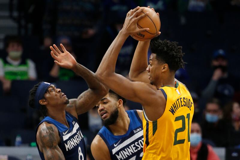 Utah Jazz center Hassan Whiteside looks for his move as Minnesota Timberwolves forward Jarred Vanderbilt defends.