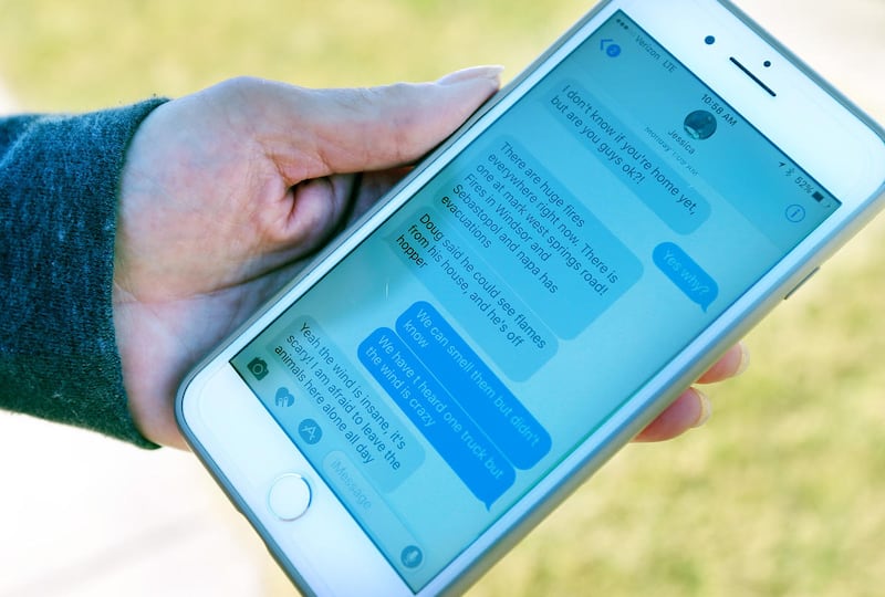 Janet Reisner shows text messages from her daughter the night of the fire as she and her husband Jack describe a fire in Santa Rosa, on Saturday, Oct. 14, 2017.