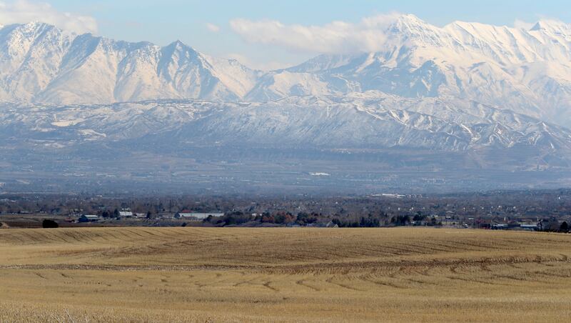 FILE - Land between 6300 West and 8500 West and 12400 South and 13100 South in unincorporated Salt Lake County, foreground, that is proposed for the Olympia Hills development on Monday, March 11, 2019.
