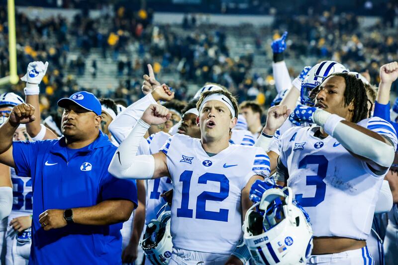 BYU QB Jake Retzlaff (12) joins teammates and coaches