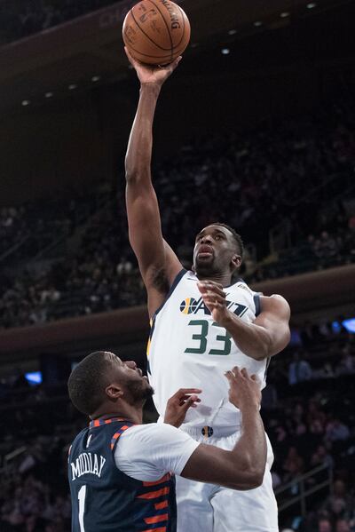 Utah Jazz center Ekpe Udoh (33) shoots a 3-pointer over New York Knicks guard Emmanuel Mudiay (1) during the second half of an NBA basketball game Wednesday, March 20, 2019, at Madison Square Garden in New York. The Jazz won 137-116. (AP Photo/Mary Altaff
