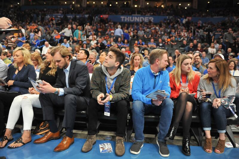 Fans wait for an announcement on the status of an NBA game between Oklahoma City and Utah in Oklahoma City, March 11, 2020.
