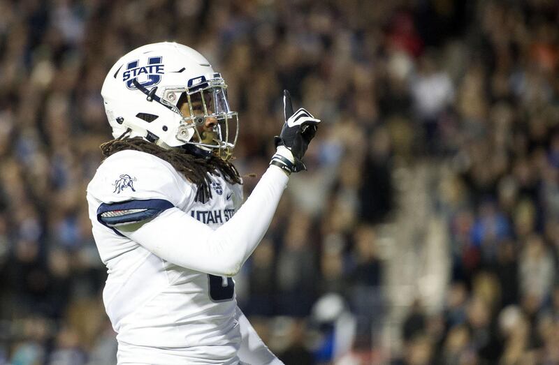 Utah State cornerback Wesley Bailey (8) signals to Brigham Young fans after making a play during an NCAA college football game in Provo on Saturday, Nov. 26, 2016.