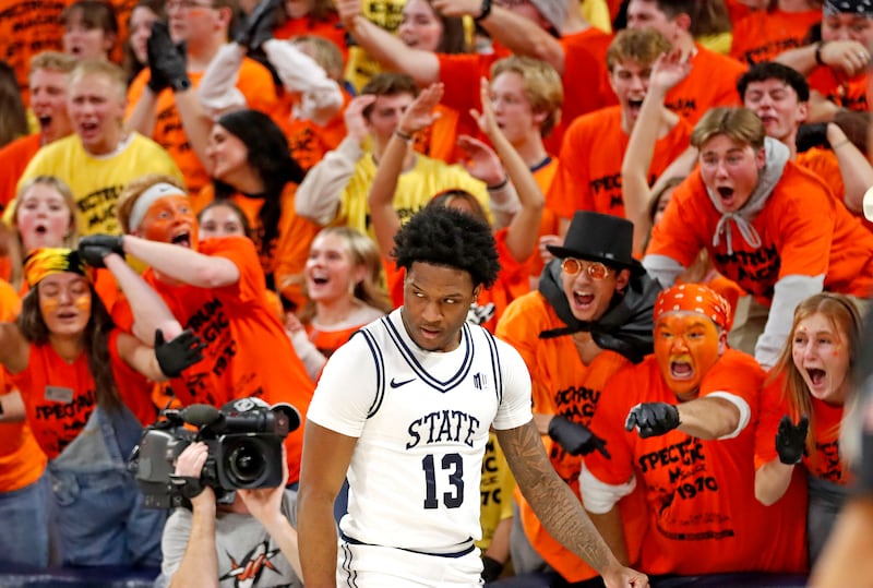 The Utah State student section celebrates after Aggie guard Deyton Albury (13) is fouled while driving to the basket for a score during USU’s loss to New Mexico on Feb. 1, at the Spectrum in Logan.