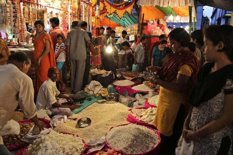 Indians buy foods as offering materials for worship at a roadside market prior to Diwali in Kolkata, India, Wednesday, Oct. 22, 2014. Diwali, the Hindu festival of lights will be celebrated is most parts of India on Oct. 23.(AP Photo/ Bikas Das)