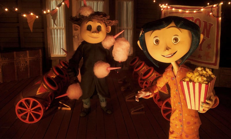 In the Other World, Wybie (voiced by Robert Bailey Jr.) and Coraline (voiced by Dakota Fanning) are drawn to a circus.