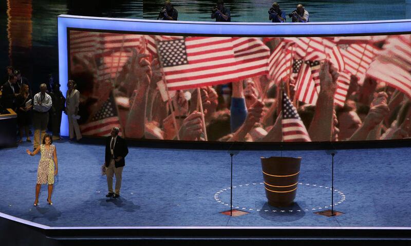 First Lady Michelle Obama waves to volunteers during a sound check for the Democratic National Convention in Charlotte, N.C., on Monday, Sept. 3, 2012.