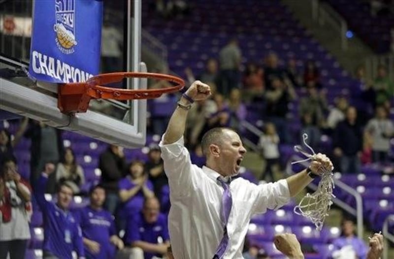 Weber State head coach Randy Rahe celebrates after cutting down the net following their NCAA college basketball game in the championship of the Big Sky Conference tournament against North Dakota Saturday, March 15, 2014, in Ogden, Utah. Weber State won 88