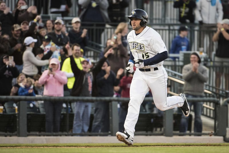 Columbia Fireflies' Tim Tebow approaches home plate after hitting a home run in his first at-bat for the team, in a minor league baseball game against the Augusta GreenJackets on Thursday, April 6, 2017, in Columbia, S.C. (AP Photo/Sean Rayford)