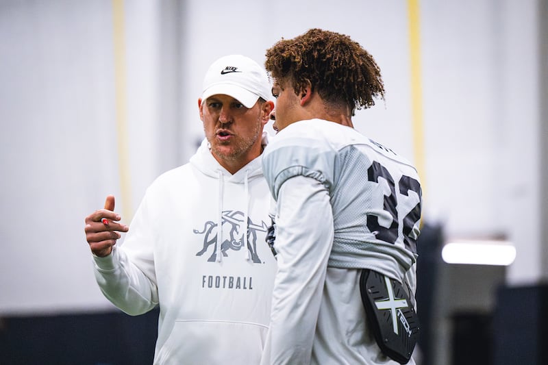 Utah State defensive coordinator Nick Howell instructs a player during practice in Logan.