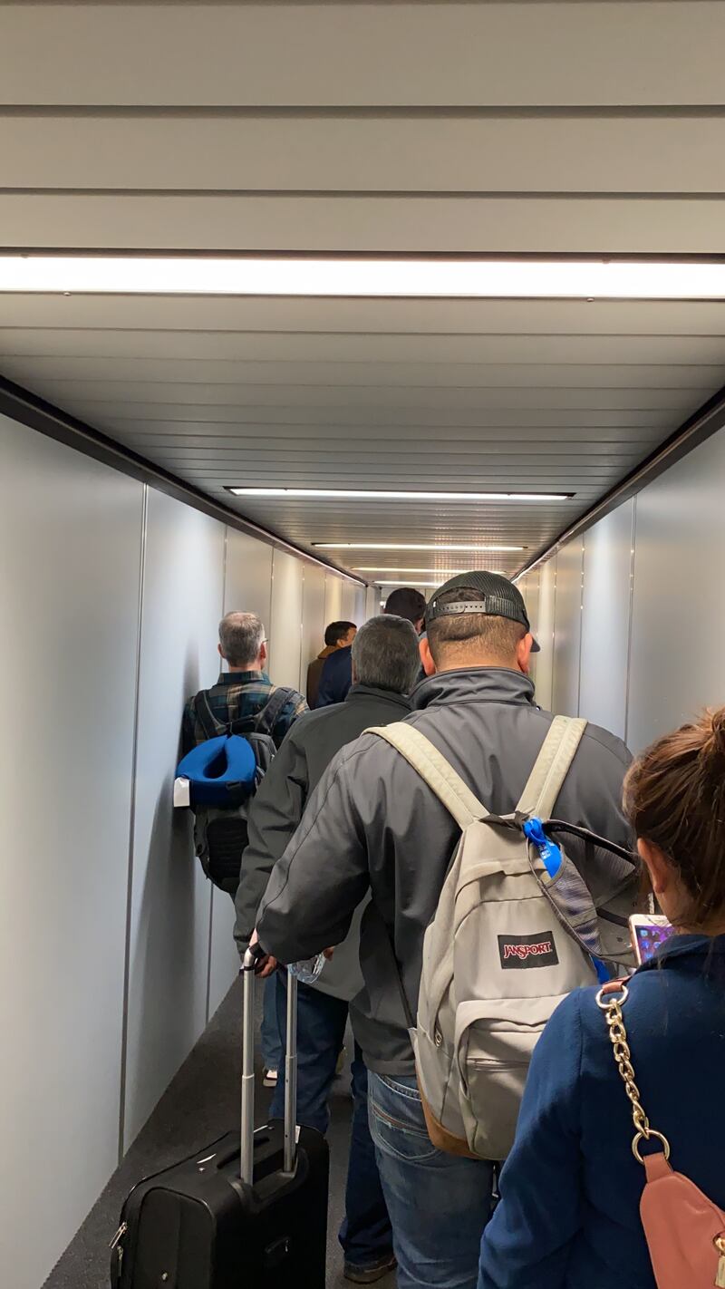 A line of passengers wait to board a flight to Dallas from Salt Lake City, Utah, in March 2020.
