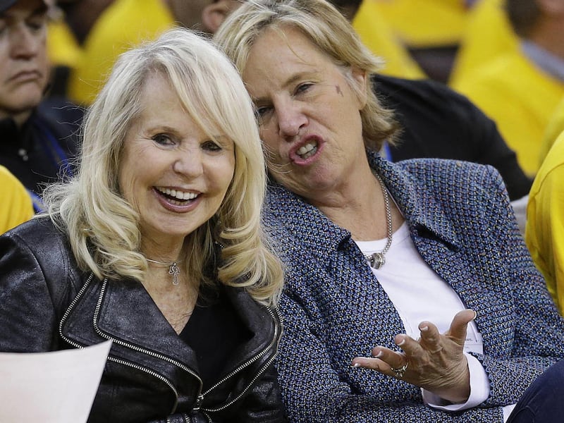 Shelley Sterling, left, wife of Los Angeles Clippers owner Donald Sterling, watches from a court side seat during the second half in Game 4 of an opening-round NBA basketball playoff series between the Clippers and Golden State Warriors on Sunday, April 2