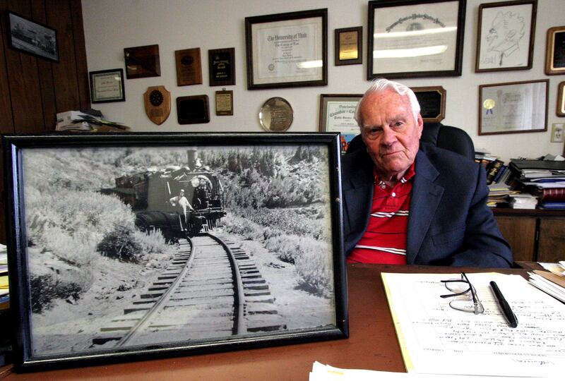 John Beaslin, an attorney in Vernal, displays a photo of his late father, also named John, who was a conductor on the Uintah Railroad.