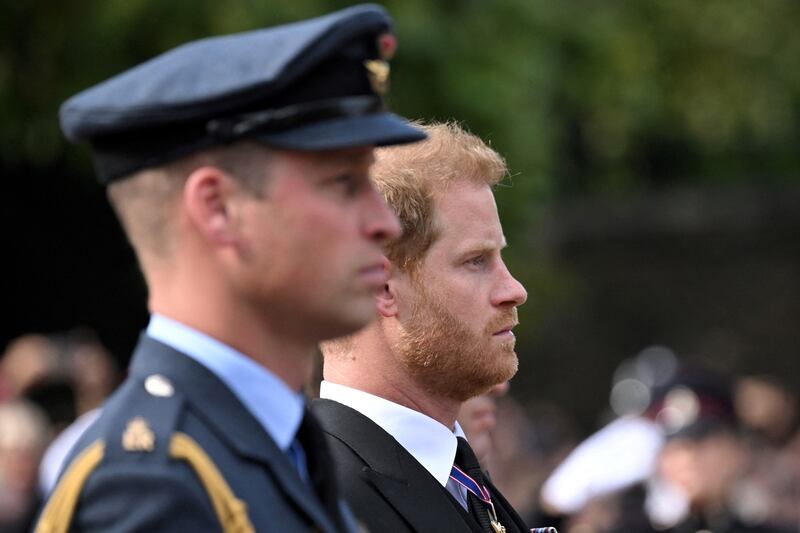 Britain’s Prince William and Prince Harry follow the coffin of Queen Elizabeth II during a procession in London on Sept. 14, 2022.
