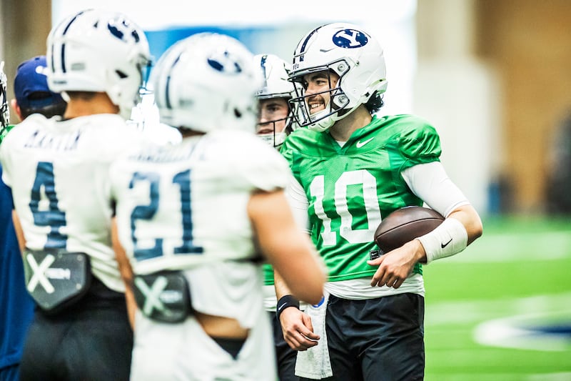 Western Michigan transfer QB Treyson Bourguet talks to teammates during a spring practice March 5, 2025, in Provo.