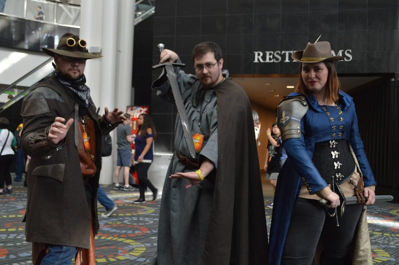 Robert Stefanik (left), 25, from Salt Lake City is dressed as a cowboy assassin. Jordan Dumpert (center), 25, from West Point, is dressed as a wizard. Cayna Storey (right), 34, from Rangeland Colorado, is dressed as a musketeer.