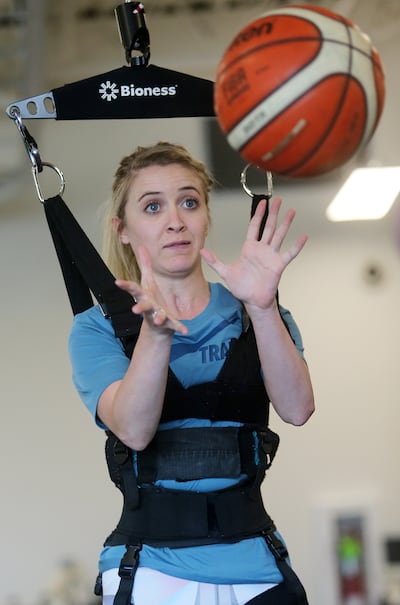 Kendal Levine, who was hit by a car while on a mission in Australia, tries to catch a basketball as she works with physical therapist Marissa Moran at Neuroworx in Sandy on Thursday, April 25, 2019.