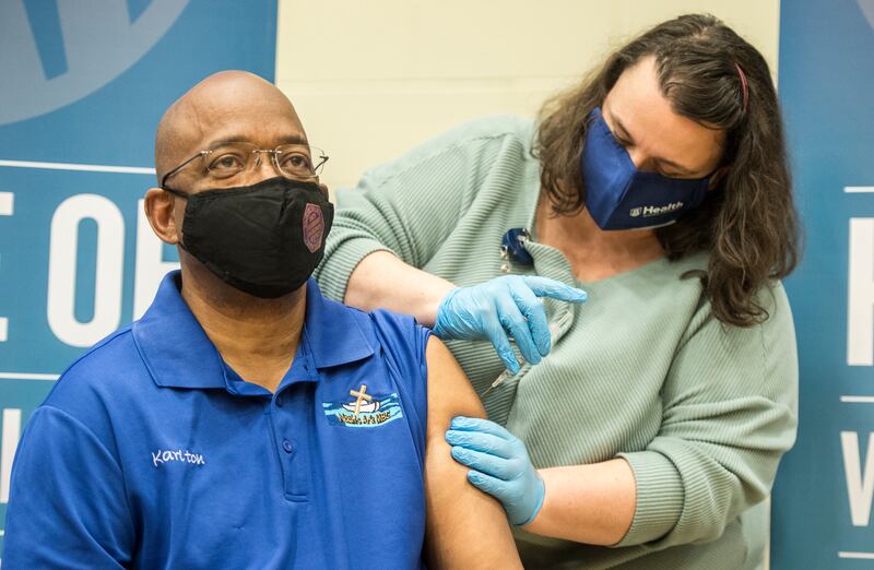 Marie Hageman administers a COVID-19 vaccine to Pastor Karlton Howard of Noah’s Ark Missionary Baptist Church in Keysville, Ga., Monday, Jan. 25, 2021, during an event for pastors at Good Shepherd Baptist Church in Augusta, Ga.