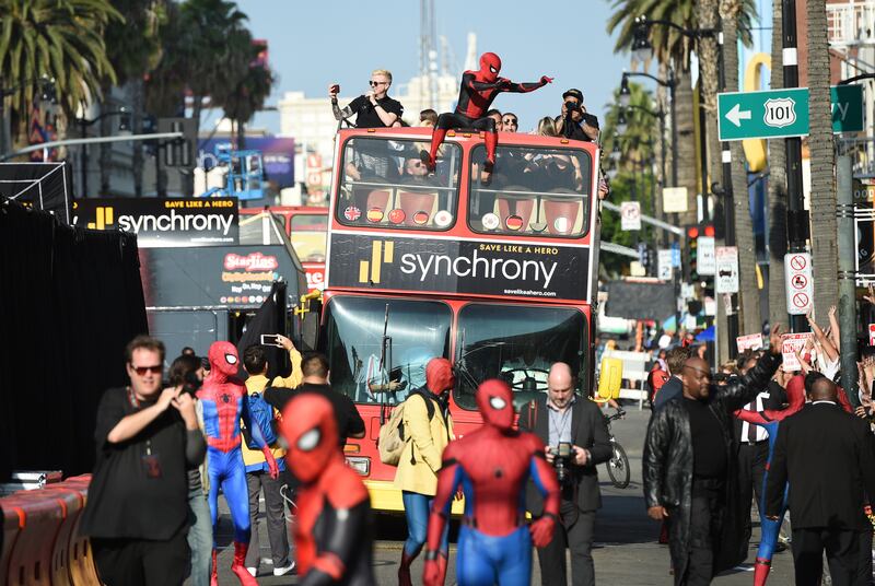 Characters from “Spider-Man: Far From Home” greet fans as they walk along Hollywood Blvd. and ride a double-decker bus at the film’s world premiere on Wednesday, June 26, 2019, at the TCL Chinese Theatre in Los Angeles. (Photo by Chris Pizzello/Invision/AP)