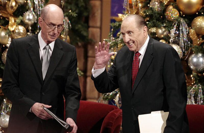 President Thomas S. Monson, right, waves to the crowd as he and President Henry B. Eyring, left, take the stand before the annual First Presidency Devotional at the LDS Conference Center Sunday, Dec. 6.