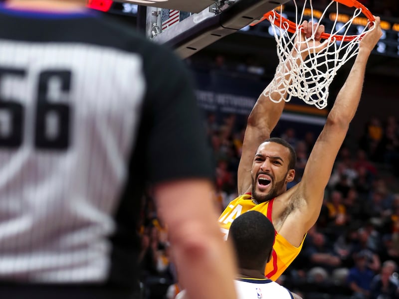 Utah Jazz center Rudy Gobert (27) throws down a dunk during the Utah Jazz versus Denver Nuggets NBA game at Vivint Arena in Salt Lake City on Tuesday, April 9, 2019.