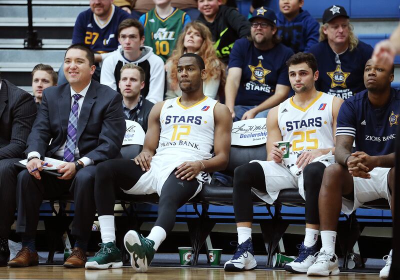 Former Salt Lake City Stars players Alec Burks and Raul Neto sit on the bench during a game against the Grand Rapids Drive.