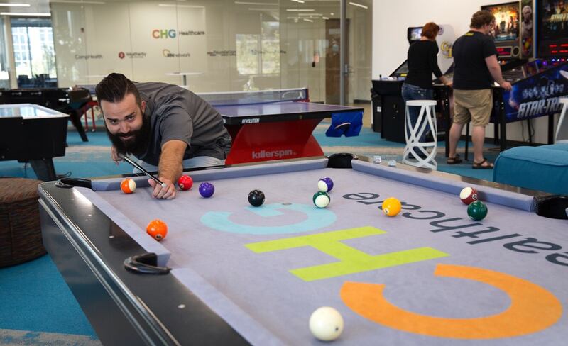 A CHG Healthcare employee plays pool in the company's headquarters in Salt Lake City.