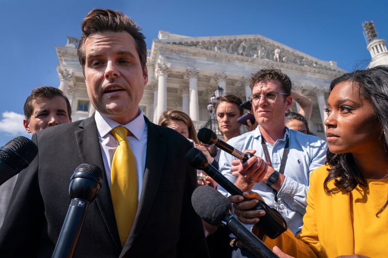 Rep. Matt Gaetz, R-Fla., left, answers questions from members of the media after speaking on the House floor in Washington on Oct. 2, 2023.