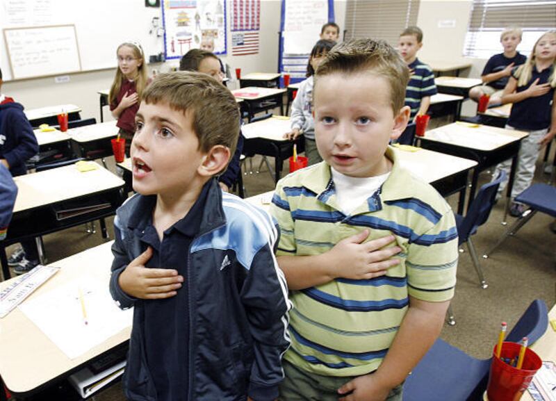 Oquirrh Mountain Charter School students Sam Browning, left, and Luke Hansen recite the Pledge of Allegiance at the school in Kaysville on Sept. 29.
