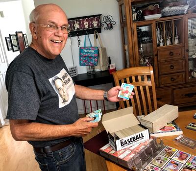 Dave Avila, 70, shows off baseball cards he collected when he was a boy growing up in Lark.