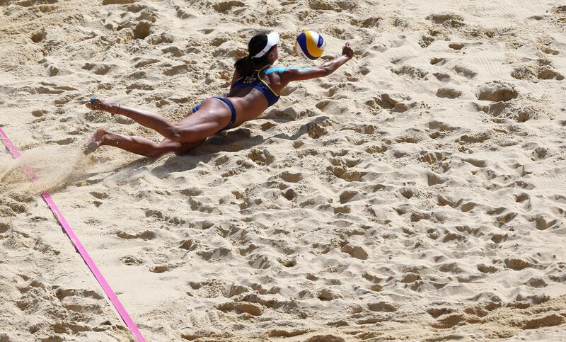 Xue Chen from China dives for a ball during the Beach Volleyball match against Switzerland at the 2012 Summer Olympics, Monday, July 30, 2012, in London.