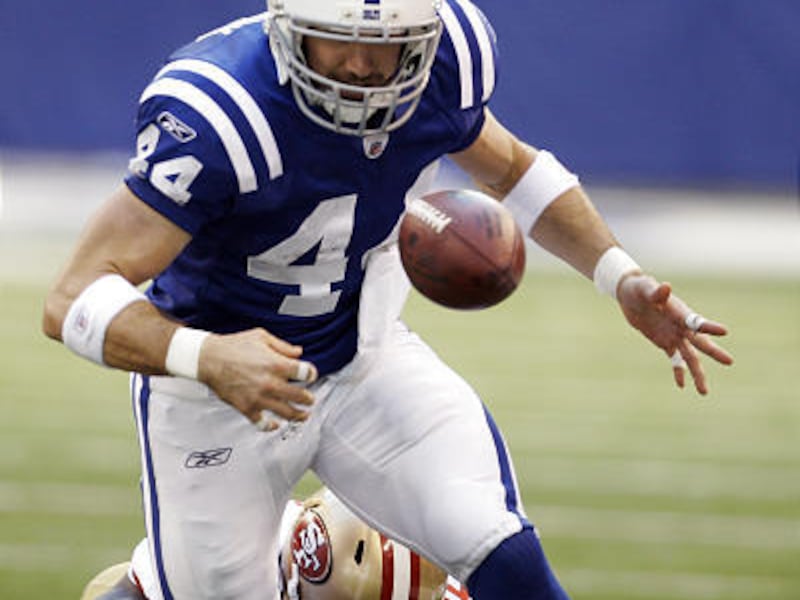 Indianapolis Colts tight end Dallas Clark (4) fumbles after being tackled by San Francisco 49ers safety Michael Lewis during the second quarter in Indianapolis Sunday.