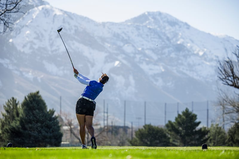 A member of BYU’s women’s golf team tees off