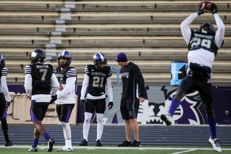 Weber State football head coach Jay hill works with players during practice at Stewart Stadium in Ogden on Tuesday, Nov. 22, 2016.