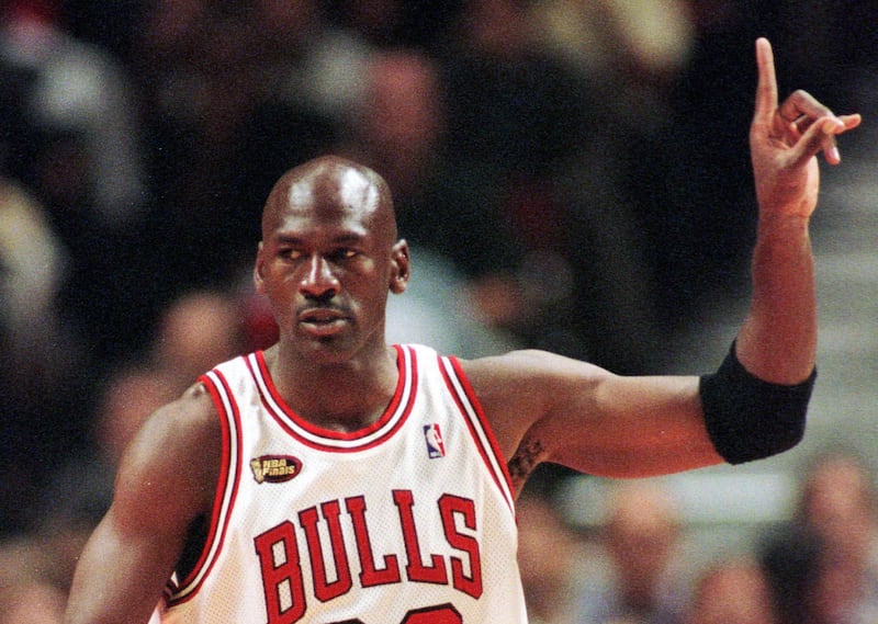 Chicago Bulls guard Michael Jordan signals to his teammates during Game 5 of the NBA Finals on June 12, 1998.