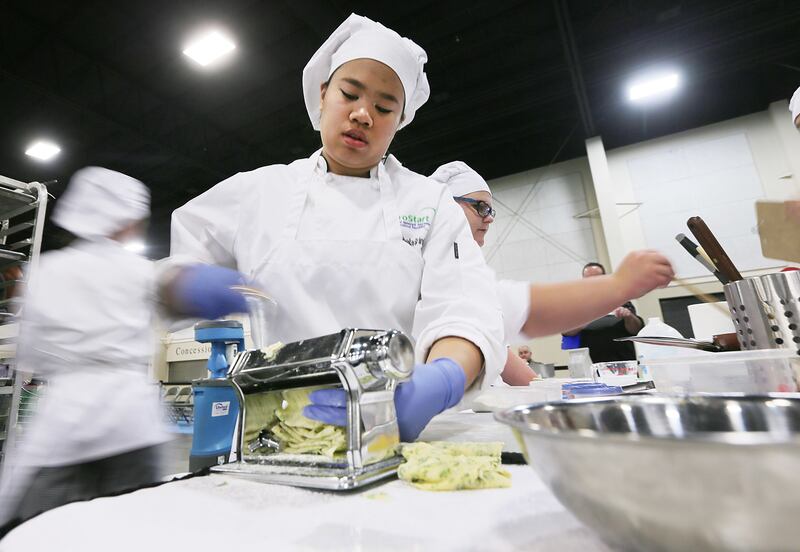 Isabela Grinkaiw works to prepare food as Utah high schools compete in the Utah Restaurant Association's annual ProStart State Championship culinary and management competitions at the Mountain America Expo Center in Sandy on Tuesday, March 6, 2018.