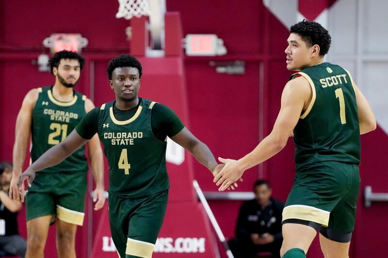 Colorado State guard Isaiah Stevens (4) greets forward Joel Scott after a basket during the second half of the team’s NCAA college basketball game against Loyola Marymount on Friday, Dec. 22, 2023, in Los Angeles. (AP Photo/Ryan Sun)