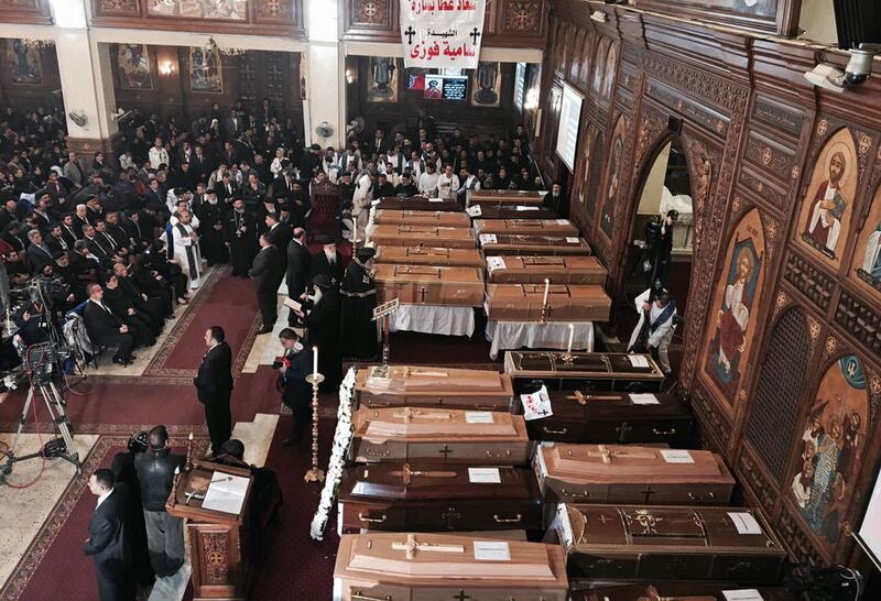 The spiritual leader of Egypt's Orthodox Christians, Pope Tawadros II, center, leads the funeral service for victims of a Sunday cathedral bombing, at the Virgin Mary Church, in Cairo, Egypt, Monday, Dec. 12, 2016. Egyptians held prayers for 25 Christians