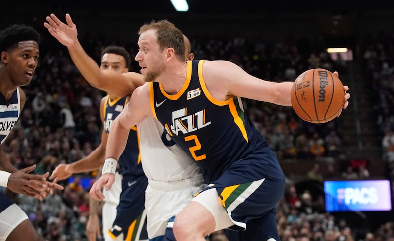 Utah Jazz guard Joe Ingles goes past Minnesota Timberwolves defenders during an NBA game