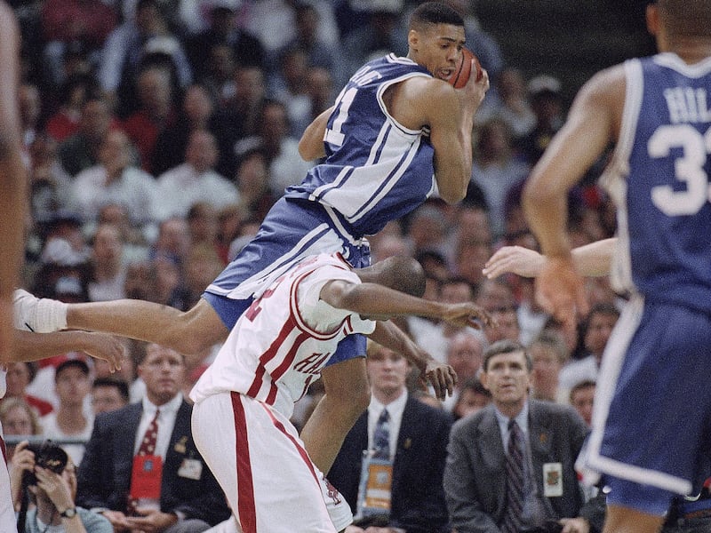 Dukes Antonio Lang, center, comes down on Arkansas Clint McDaniel during the first half of the NCAA Final Four Championship game, Monday, April 4, 1994, Charlotte, N.C. (AP Photo/Bob Jordan)
