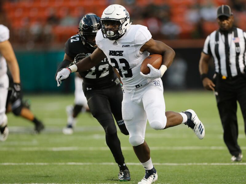 Rice running back Emmanuel Esukpa (33) runs away from Hawaii defensive back Ikem Okeke (22) for a touchdown during the first quarter of an NCAA college football game Saturday, Sept. 8, 2018, in Honolulu.