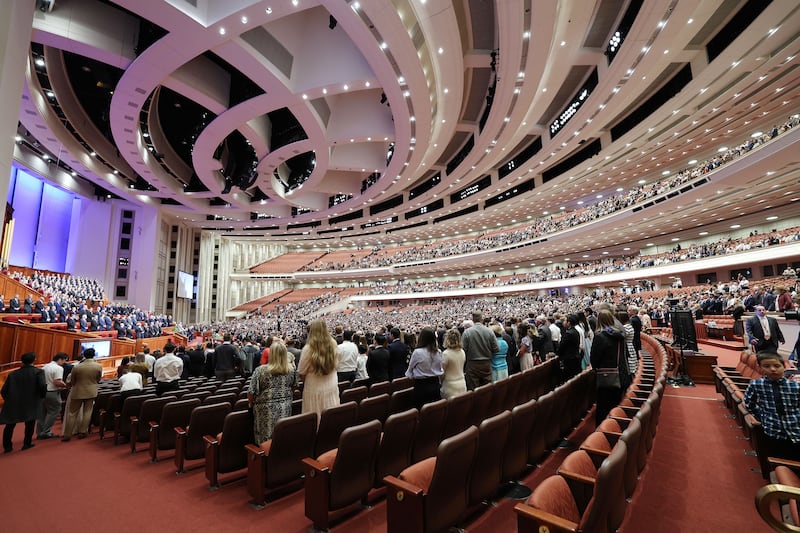 Conferencegoers stand as general authorities enter the Conference Center.