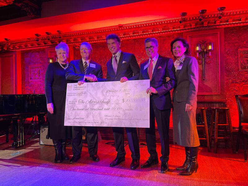 Tony Award winner Brian Stokes Mitchell, center, accepts a $100,000 donation to the Actors Fund from the Tabernacle Choir.