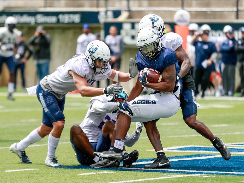 Utah State’s Bryan Cobbs gets wrapped up during spring game in Logan on Saturday, April 23, 2023.