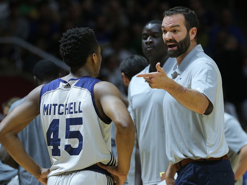 Utah Jazz assistant coach Alex Jensen speaks with guard Donovan Mitchell in Summer League action.